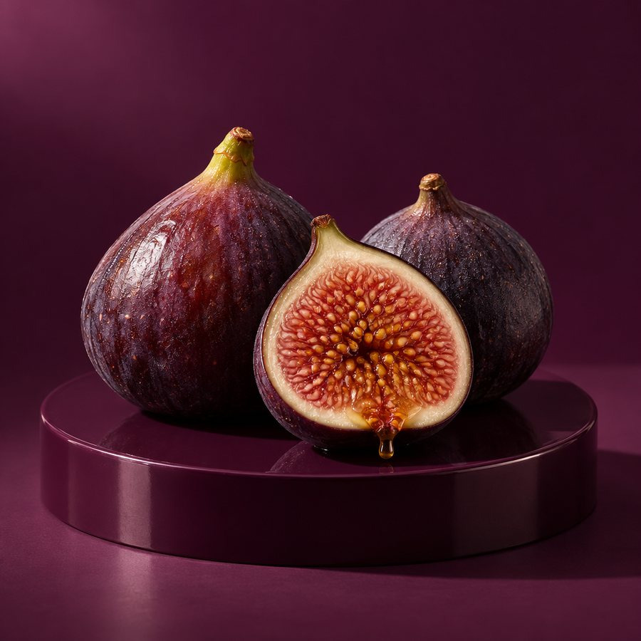 Three purple figs, one halved, on an aubergine set